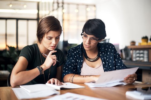 Shot of two women working on a project together in a workshop