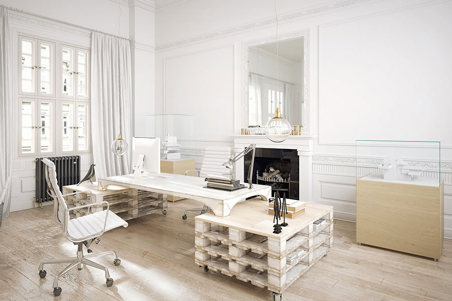 Das Bild zeigt ein helles Büro mit einem Tisch aus weiss getünchten Paletten – DIY-Ideen für Upcycling-Materialien